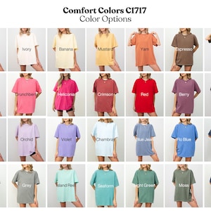 May include: A grid of t-shirts in various colors, including white, ivory, and black. The text "Comfort Colors C1717 Color Options" is at the top. Each shirt is displayed on a person.