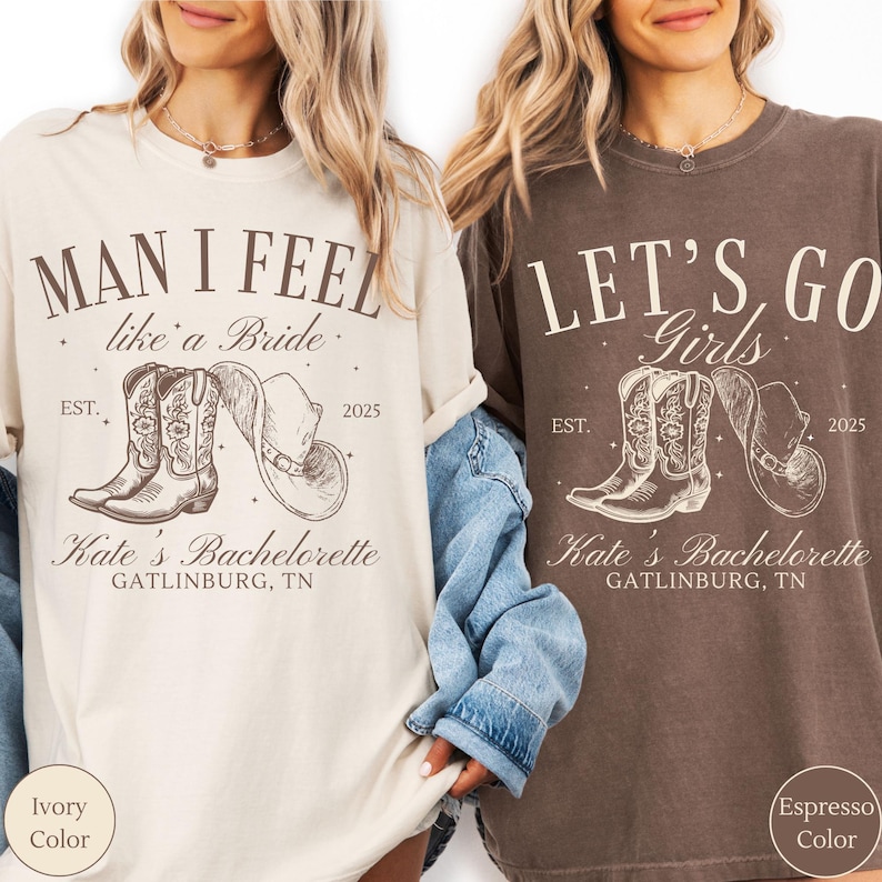 May include: Two t-shirts, one ivory and one espresso, with a western theme. The ivory shirt says "Man I Feel like a Bride" and the espresso shirt says "Let's Go Girls." Both shirts feature cowboy boots, a hat, and the text "Kate's Bachelorette, Gatlinburg, TN."