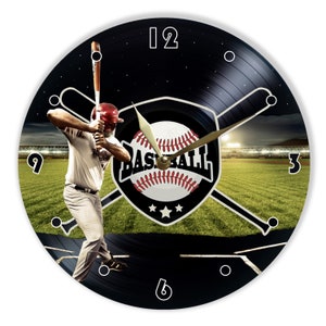 May include: A black vinyl record clock with a baseball theme. The clock face features a baseball player swinging a bat, a baseball with crossed bats, and the word "BASEBALL". The clock has a black background with white numbers and a gold-colored hour hand.