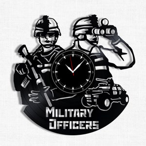 May include: Black vinyl record clock featuring a silhouette of two military officers, one holding a rifle and the other looking through binoculars. The clock face is black with white numbers and hands. The text "MILITARY OFFICERS" is printed below the clock face.