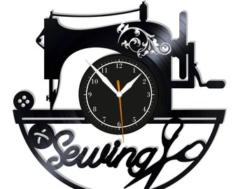 May include: Black vinyl record clock with a silhouette of a sewing machine, a spool of thread, and scissors. The clock face is black with white numbers and hands. The words "Sewing" are written in a decorative font below the clock face.