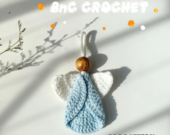 May include: Crochet angel ornament with white wings and a light blue dress. The angel has a wooden bead head and is hanging from a string. The text "PDF PATTERN" is visible at the bottom of the image.