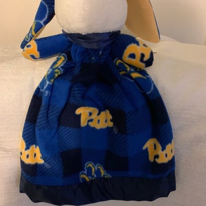 May include: Blue and yellow fleece baby blanket with a bunny head attached. The blanket has a plaid pattern with the word "Pitt" repeated on it.