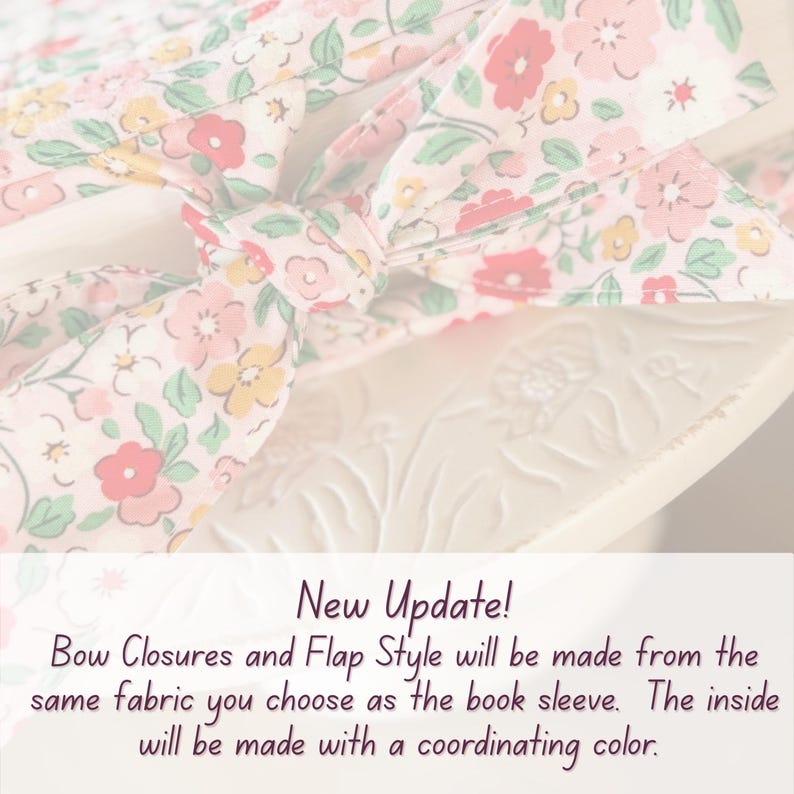 May include: A close-up of a floral fabric book sleeve with a bow closure. The fabric features a pattern of pink, red, and yellow flowers on a cream background. The text "New Update!" is visible.