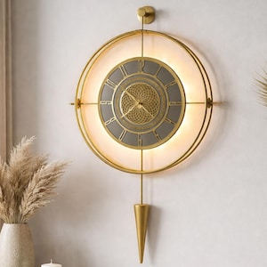 Modern Gold Metal Wall Clock with Pandelum, LED Accent Lighting, Battery Operated
