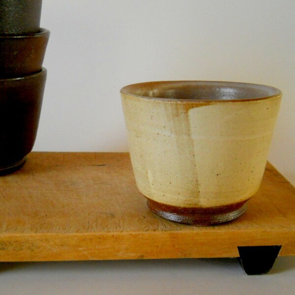 Small bowl with light blonde slip over dark brown clay, rustic modern pottery