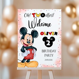 May include: A welcome sign for a second birthday party featuring Mickey Mouse. The sign reads "Oh! TWOodles! Welcome Oliver 2nd Birthday Party 24.08.2026" with a cartoon image of Mickey Mouse.