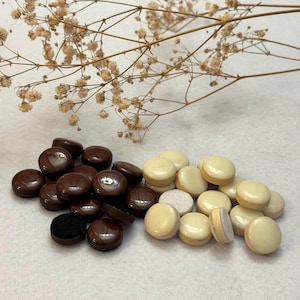 May include: A set of three ceramic mugs with a speckled, matte finish. The mugs are in shades of cream, light gray, and dark gray. Each mug has a simple, minimalist design and a rounded handle. Perfect for coffee or tea.