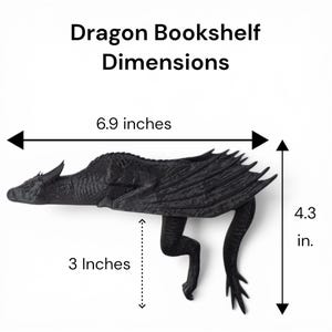 May include: A black dragon bookshelf decor piece with text reading Dragon Bookshelf Dimensions. The dragon measures 6.9 inches in length, 4.3 inches in height, and has a 3 inch section indicated by arrows, showing its detailed scale and wing texture.