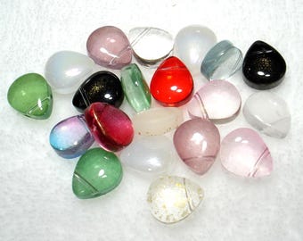 May include: Assortment of glass teardrop beads in various colors, including clear, green, red, pink, and black. The beads have a smooth, polished finish and are perfect for jewelry making.