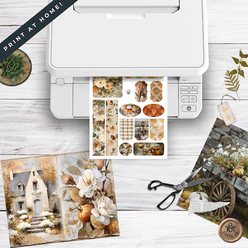May include: A white printer is shown printing a sheet of stickers with floral and autumn-themed designs. The image includes a succulent, a pair of scissors, and a watercolour painting of a house and flowers. The text "PRINT AT HOME!" is visible.