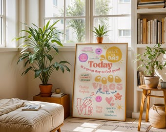 May include: A framed poster with the words "Today is a great day to feel good" in a retro font. The poster has a light wood frame and is surrounded by potted plants and a neutral-toned ottoman. The text includes the words "Good Vibes" and "Sparkle with Kindness."