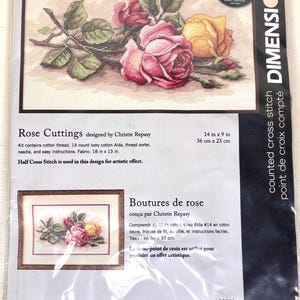 May include: A Dimensions counted cross stitch kit titled "Rose Cuttings" designed by Christie Repasy. The kit includes cotton thread, Aida fabric, a thread sorter, needle, and instructions. The finished design measures 14 inches by 9 inches.
