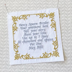 May include: White square fabric with embroidered gold filigree border and text. The text reads "Fancy Square Border, Your sentiment here, Tell your story, Share your love, Use up to 7 lines, 20 characters and spaces, Per line, May 2022."