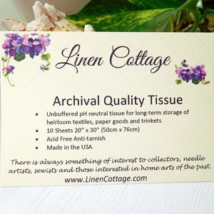 May include: A cream-colored card with the text "Linen Cottage" and "Archival Quality Tissue." The card features purple floral illustrations. The text describes the tissue as unbuffered, acid-free, and ideal for storing textiles and paper goods. The card is made in the USA.