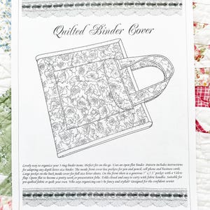 May include: Line drawing of a quilted binder cover with a floral pattern. The cover has a handle and a pocket. Text at the top reads "Quilted Binder Cover". The image is on a white background with decorative borders.