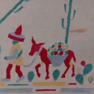 May include: A white fabric featuring a colorful screen-printed design of a person wearing a red sombrero and yellow tunic walking beside a red donkey carrying a basket of fruit. The scene includes green cacti and a horizontal striped border at the bottom.