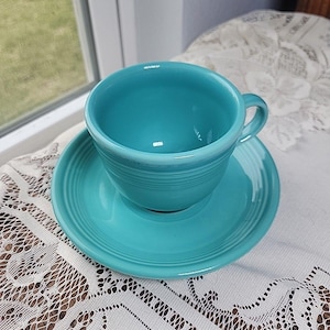 May include: A set of three ceramic mugs with a speckled, matte finish. The mugs are in shades of cream, light gray, and dark gray. Each mug has a simple, minimalist design, perfect for coffee or tea.