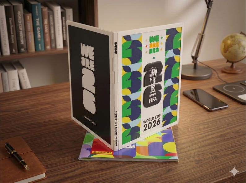 May include: A Panini official sticker collection album for the FIFA World Cup 2026. The album features a black cover with white text reading WE ARE 26 and a white cover with green, yellow, and blue patterns, the FIFA trophy logo, and text.