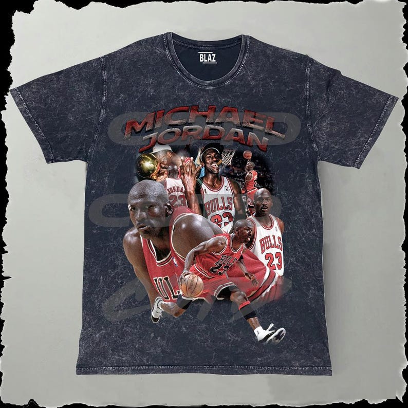 May include: A black t-shirt with a faded, vintage look featuring a collage of Michael Jordan images in red and white Bulls jerseys. The text "MICHAEL JORDAN" is printed in white on the shirt.