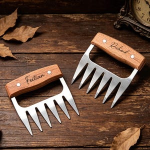 May include: Two stainless steel meat shredding claws with wooden handles. Each handle is secured with two silver rivets and features custom laser-engraved text, with one reading Feitian and the other reading Richard in a cursive script font.