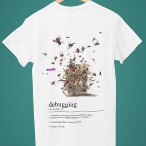 May include: White t-shirt with a humorous definition of "debugging" printed on the back. The definition includes the phrase "fixing a fuck-up" and an illustration of a computer bug with a swarm of bees.