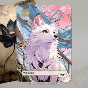 May include: A rectangular trading card featuring a white fox illustration with the text Fox, Vigilance, and 2/2. The background shows a pink sky and brown branches. A second card behind it displays a dark lotus flower on a beige background.