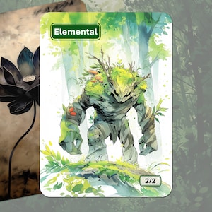 Op de afbeelding: Twee fantasy art kaarten. Eén toont een zwarte lotusbloem. De andere kaart heeft een groene rand met het woord "Elemental" en een aquarel illustratie van een met mos bedekte golem met het nummer "2/2" onderaan.