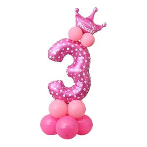 May include: Pink number three balloon with white polka dots and a pink crown with the text "Happy Birthday Princess". The balloon is surrounded by smaller pink balloons.