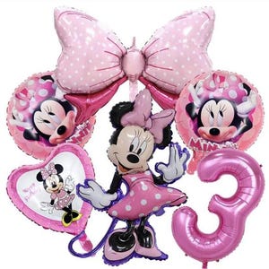 May include: Pink and white Minnie Mouse themed balloon bouquet with a large pink bow, a Minnie Mouse character balloon, a heart-shaped balloon with a Minnie Mouse image and the text "Happy Birthday", and a large pink number 3 balloon.