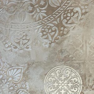 May include: A textured, beige-toned surface with a repeating pattern of white, ornate floral and geometric designs. The design elements include circular and semi-circular shapes, with a distressed, aged appearance.