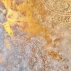 May include: Abstract artwork with a textured surface and a warm color palette. The design features intricate, embossed circular patterns with floral and ornamental details. The background has a blend of gold, brown, and gray tones, creating a vintage aesthetic.