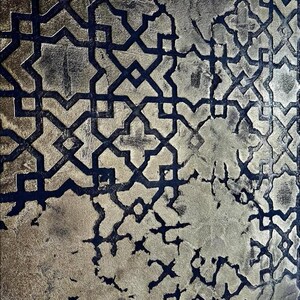 May include: Abstract pattern with a metallic gold and dark blue color scheme. The design features a repeating geometric motif with a distressed, textured appearance. The gold areas have a mottled effect, adding depth to the design.