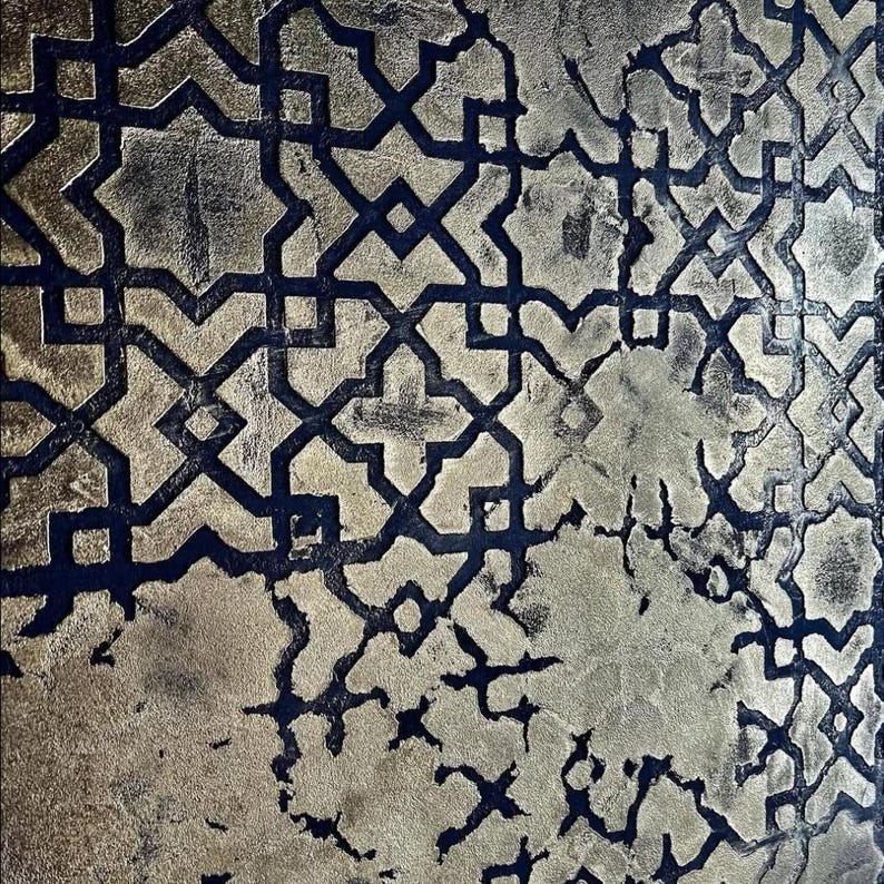 May include: Abstract pattern with a metallic gold and dark blue color scheme. The design features a repeating geometric motif with a distressed, textured appearance. The gold areas have a mottled effect, adding depth to the design.
