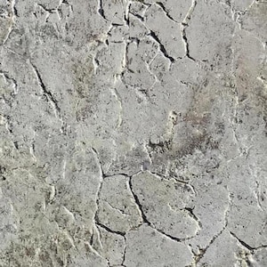 May include: A textured surface featuring a light gray and off-white color palette with a network of deep, dark fissures and cracks running across the entire area, creating a weathered, uneven appearance with varied depth and shadow throughout.