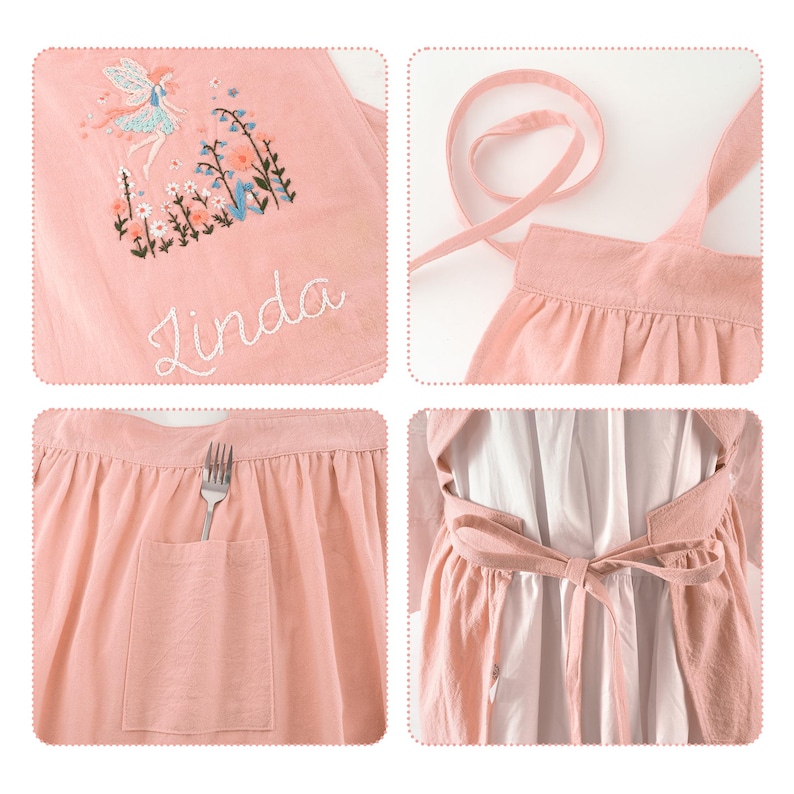 May include: A light pink apron featuring an embroidered fairy and floral design with the name Linda stitched in white thread. The apron includes a gathered waist, a front pocket containing a silver fork, and long fabric ties for securing at the back.