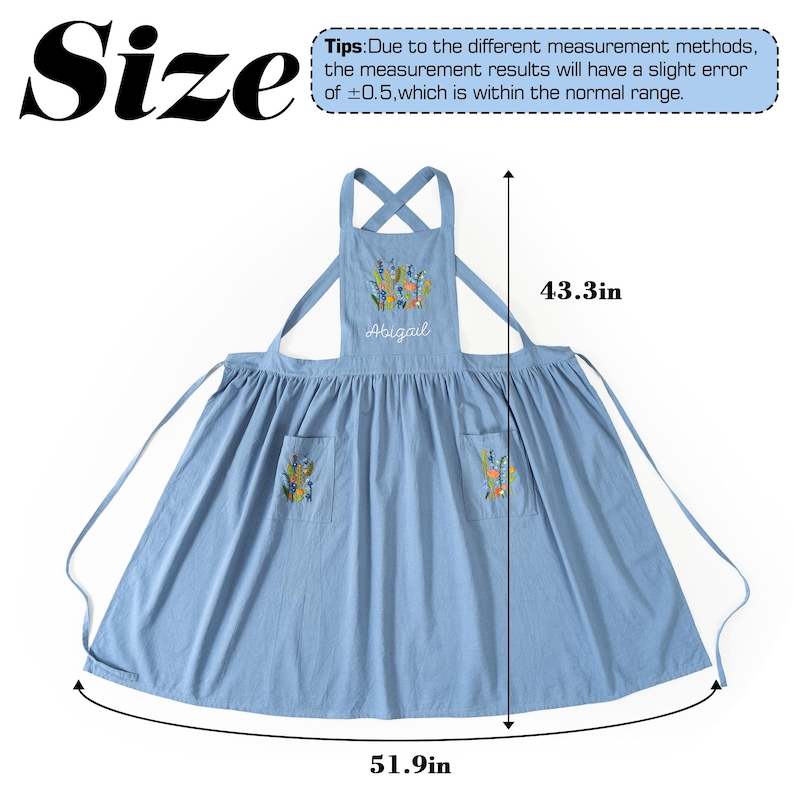 May include: A light blue apron featuring floral embroidery on the chest and two front pockets. The name Abigail is embroidered in white script on the chest. The apron measures 43.3 inches in length and 51.9 inches in width as indicated by arrows.