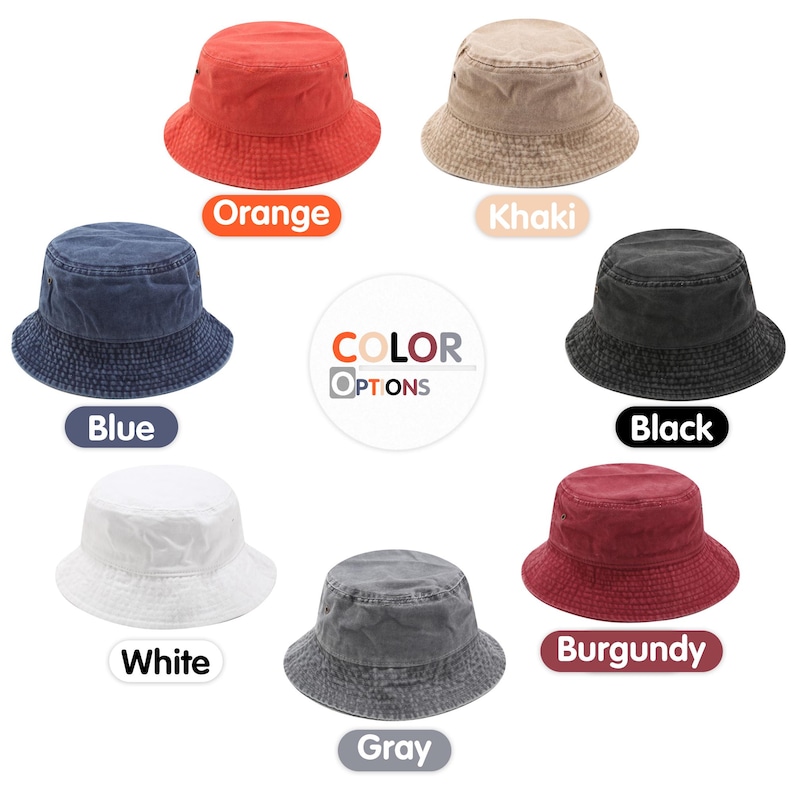 May include: Seven bucket hats arranged in a circle, each featuring a different solid color: orange, khaki, blue, black, white, gray, and burgundy. The center of the image displays the text COLOR OPTIONS, showcasing the available variety for this headwear.