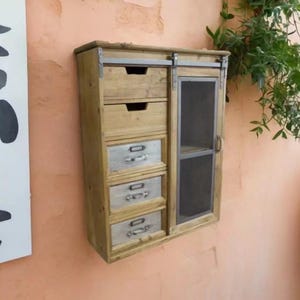 May include: A handmade wooden sign with the text "Welcome to our home" in a handwritten style. The sign is painted white with a distressed finish and features a black border. A small, decorative heart is attached to the bottom.