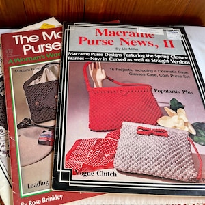 May include: A stack of vintage macrame purse pattern books. The covers feature images of finished purses in red, brown, and beige. Titles include "The Macrame Purse" and "Macrame Purse News, II".