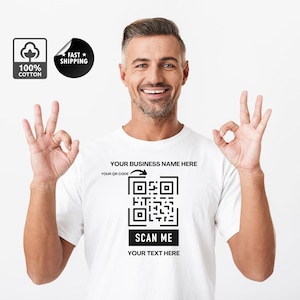 May include: White t-shirt with a black QR code and the text "YOUR BUSINESS NAME HERE", "YOUR QR CODE", "SCAN ME", and "YOUR TEXT HERE".