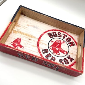 May include: Wooden serving tray with a red, white, and blue Boston Red Sox logo. The logo features a baseball and two red socks. The tray has a distressed white paint finish.