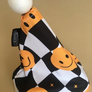 May include: A black and white chequered gear shift boot with a yellow smiley face pattern. The boot has a white ball on top and the text "SHIFT IT" on the side.