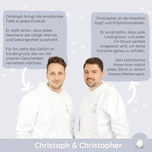 May include: Two men wearing white hoodies with a small bunny logo stand in front of a light blue background. The text "Christoph & Christopher" is at the bottom of the image. The text above the men describes their roles in the business.  The text on the left says "Christoph brings the emotional depth to every product. He makes sure that every gift radiates the necessary warmth and security." The text on the right says "Christopher is the creative mind and precision master. He ensures that every laser engraving and every UV print is perfectly implemented to fulfill your wishes exactly."