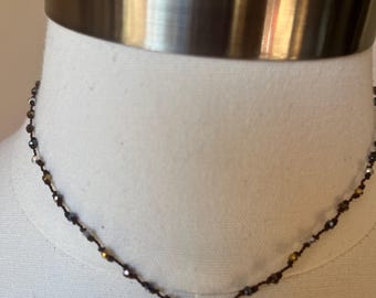 Delicate handknotted necklace with multicolored metal beads, and a gold filled ring with a sterling lotus blossom centerpiece. 14 inches