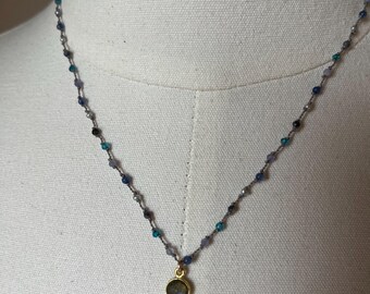 Tiny round labradorite gemstone in Goldfilled setting with Tanzanite, teal, laboradorite gems,freshwater pearls on a polymer nylon Filament.