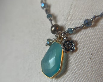 Dreamy blue chalcedony gemstone set in gold tone adorned this hand knotted necklace. This is a mediumish necklace
