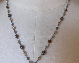 Soft earth, toe necklace with chocolate, pearls champagne, pearls and bronze pearls with green yellow and blue crystals. 19 inches