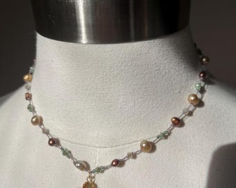 Gold plated Primrose pendant on a handknotted polymer nylon with chocolate pearls and champagne, pearls and green accents