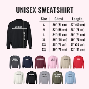May include: A black unisex sweatshirt with size and color options. The size chart shows chest measurements from 20 inches (51 cm) to 30 inches (76 cm) and lengths from 27 inches (69 cm) to 32 inches (81 cm). Available colors include dark heather, navy, maroon, and red.